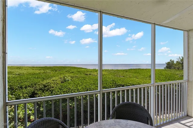 a view of balcony with floor to ceiling windows and a yard