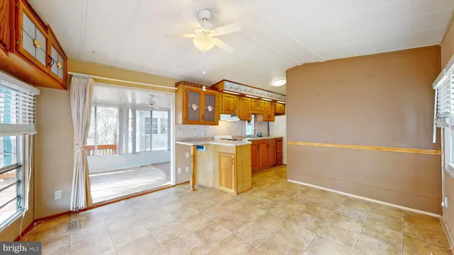 a view of a kitchen with fridge and a sink