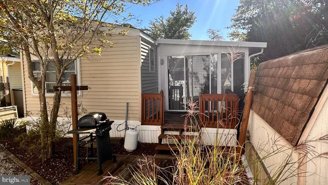 a view of a patio with table and chairs potted plants and large tree