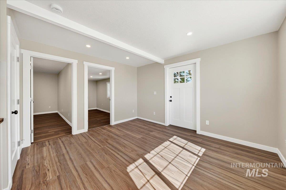 109 Parma Road Parma, ID 83660 - Photo 12 of 31 Interior space featuring luxury plank flooring, recessed lighting, neutral wall tones, white trim, and a white entry door with glass panels
