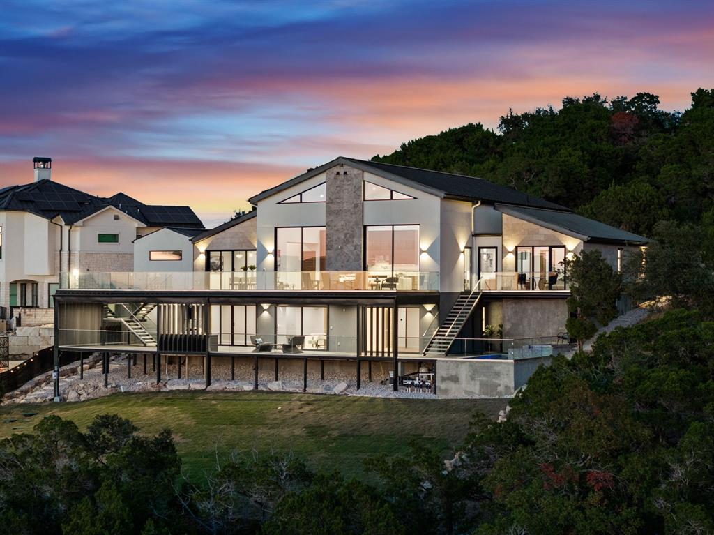 2714 Lakehurst Road Spicewood, TX 78669 - Photo 1 of 37 Rear view of house featuring stairway, a patio area, a balcony, and a yard