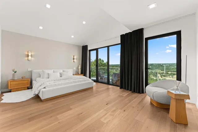 a spacious bedroom with a bed and a walk in closet