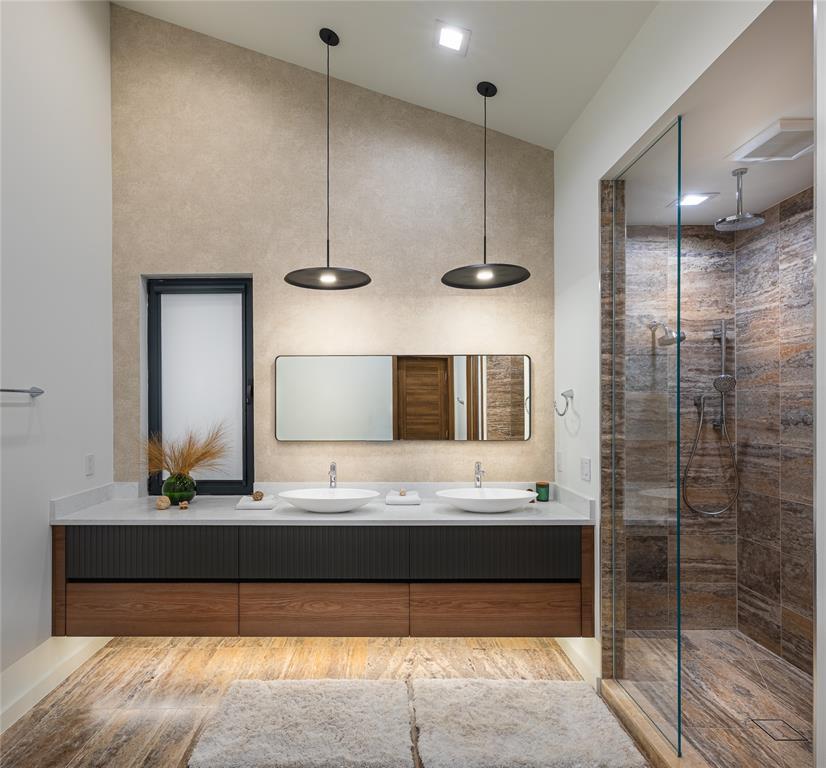 2714 Lakehurst Road Spicewood, TX 78669 - Photo 18 of 37 Bathroom with double vanity, a stall shower, and wood finished floors