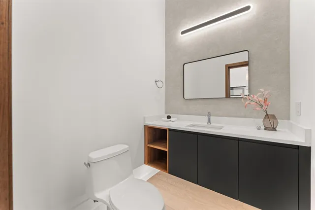 a bathroom with a sink a toilet and mirror