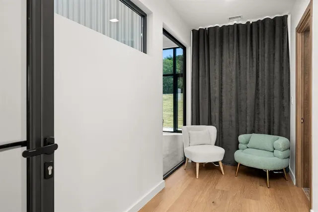 a view of a dining room with furniture window and wooden floor