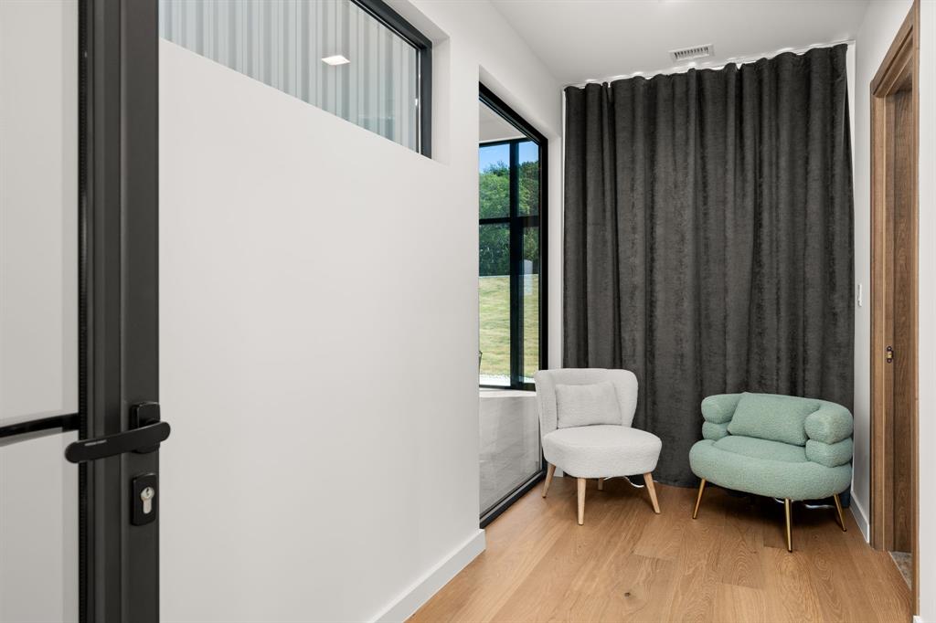 2714 Lakehurst Road Spicewood, TX 78669 - Photo 29 of 37 Living area with light wood-style floors and baseboards