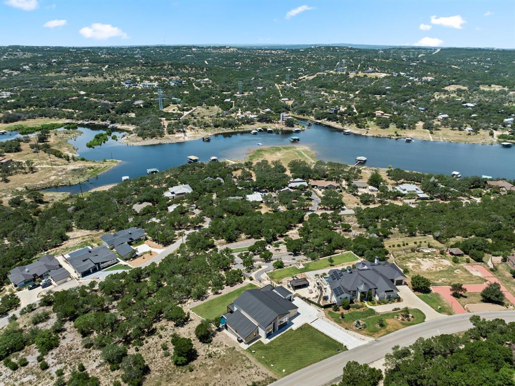 2714 Lakehurst Road Spicewood, TX 78669 - Photo 31 of 37 Aerial view of property and surrounding area with a nearby body of water and nearby suburban area