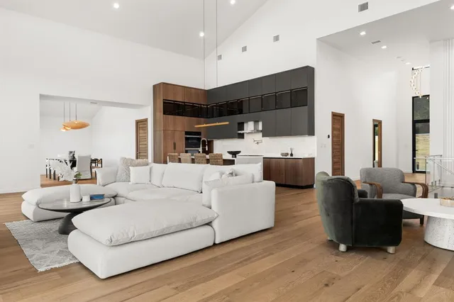 a kitchen with stainless steel appliances kitchen island granite countertop a refrigerator and a stove top oven