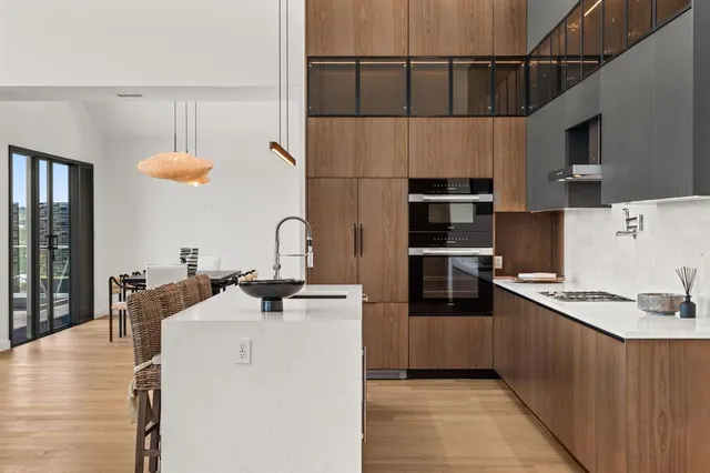 a kitchen with stainless steel appliances a sink stove and refrigerator