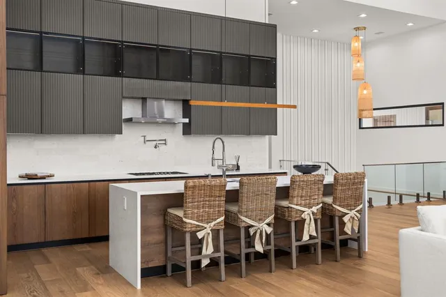 a kitchen with granite countertop a sink a stove and cabinets