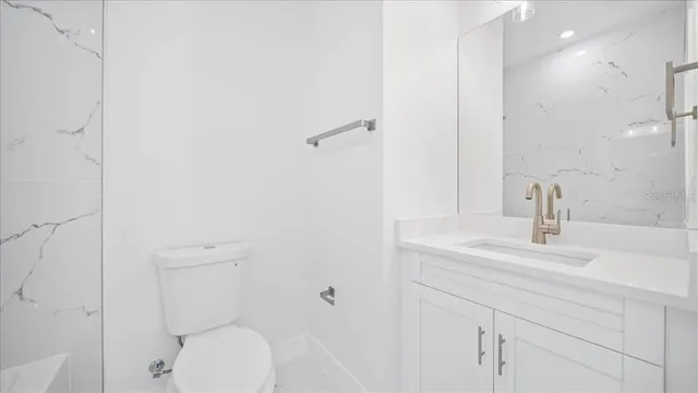 a bathroom with a bathtub and a toilet