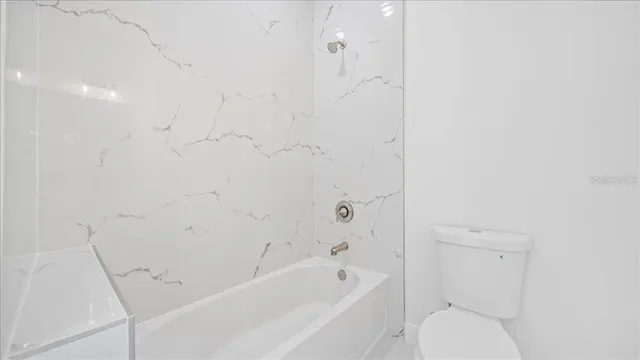 an empty room with a painting on the wall