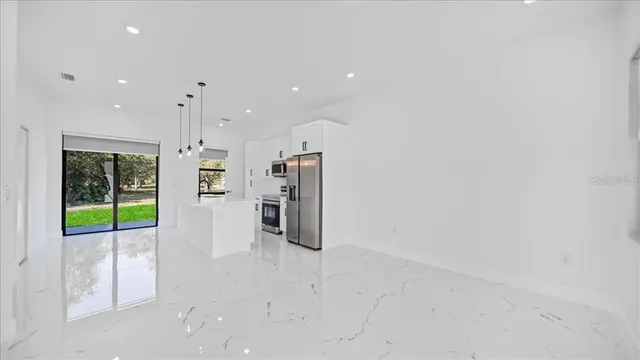 a view of an empty room with glass door