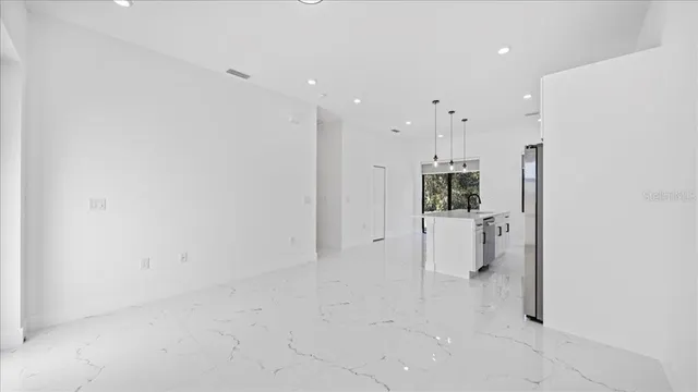 a kitchen with stainless steel appliances granite countertop a refrigerator and a sink