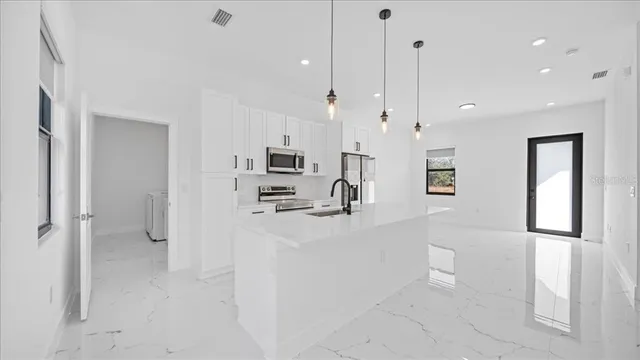 a bathroom with a granite countertop sink a mirror and shower