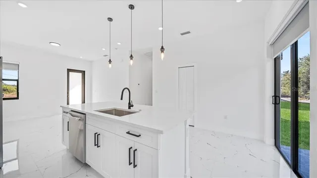 a kitchen with white cabinets and white appliances