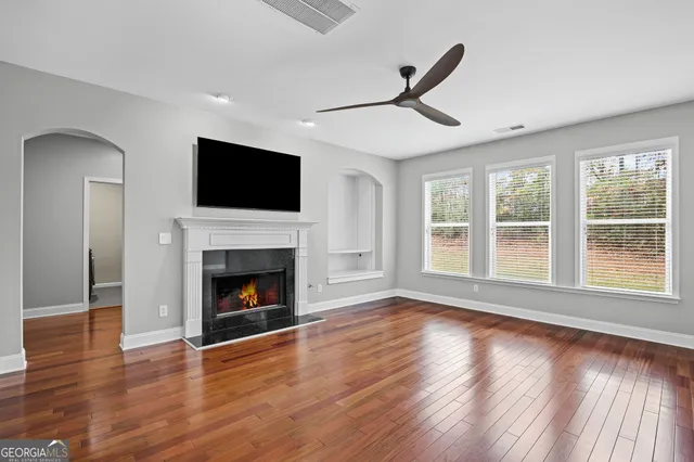 a living room with furniture fireplace and flat screen tv