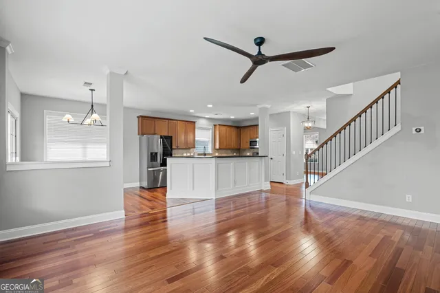 a view of a livingroom with wooden floor a fireplace and a window
