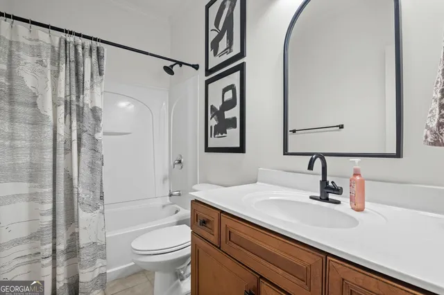an empty room with a ceiling fan and carpet