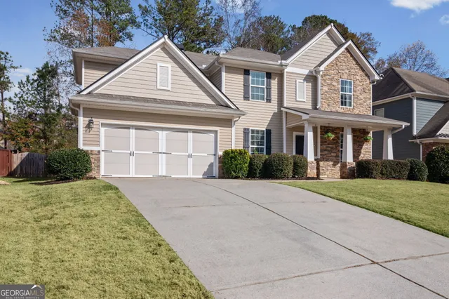 a front view of a house with a yard and garage