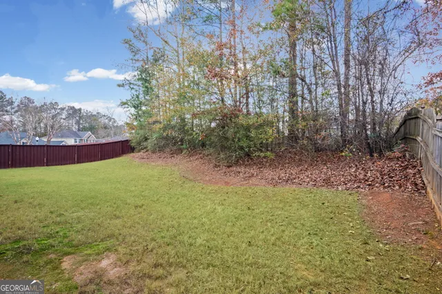 a view of a tennis ground with large trees