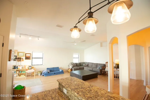 a living room with furniture and a chandelier