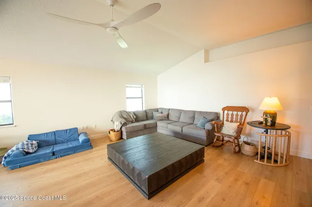 a living room with furniture and a lamp