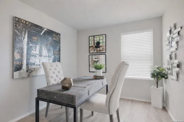 a view of a dining room with furniture and window