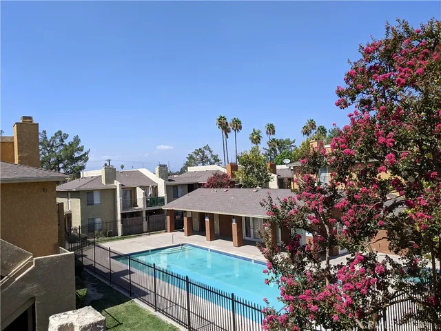 a view of a house with swimming pool and sitting area