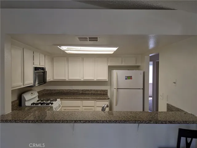 a kitchen with a refrigerator and a sink
