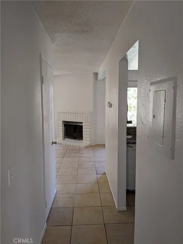 a view of an empty room with a fireplace