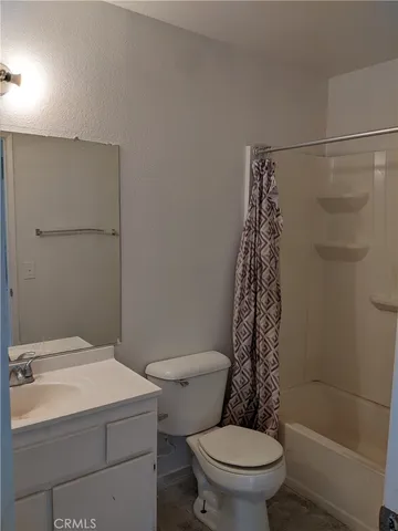 a bathroom with a toilet and shower