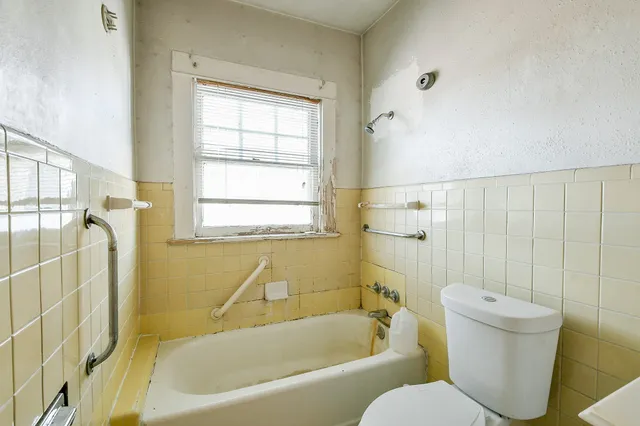 a bathroom with a toilet and bathtub