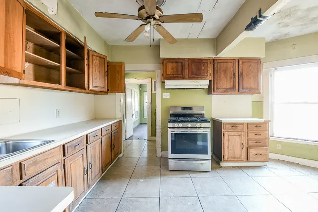 a kitchen with stainless steel appliances granite countertop a stove and a sink