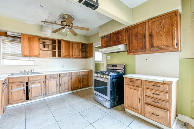 a kitchen with stainless steel appliances granite countertop a stove and cabinets