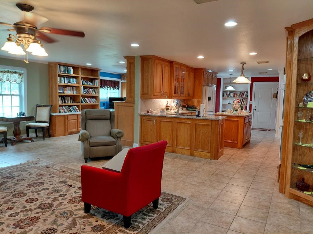 1231 County Road 201A Angleton, TX 77515 - Photo 24 of 26 a living room with stainless steel appliances kitchen island granite countertop furniture and a wooden floors