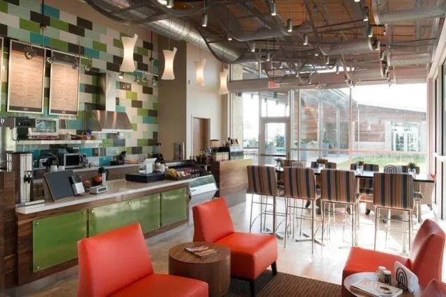 a outdoor dining area with chairs and a large window