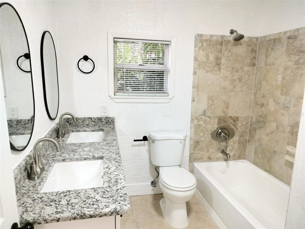 9901 Grace Drive Port Richey, FL 34668 - Photo 16 of 35 a bathroom with a sink a toilet and a bathtub