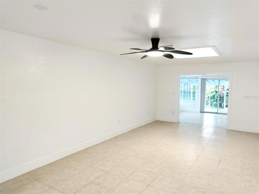 9901 Grace Drive Port Richey, FL 34668 - Photo 2 of 35 an empty room with windows and fan