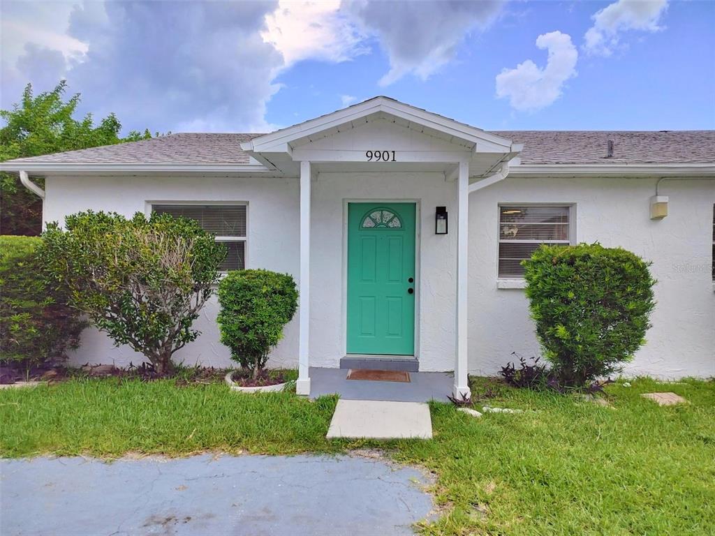 9901 Grace Drive Port Richey, FL 34668 - Photo 21 of 35 a front view of a house with garden