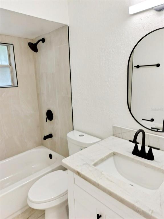 9901 Grace Drive Port Richey, FL 34668 - Photo 30 of 35 a bathroom with a sink toilet and shower