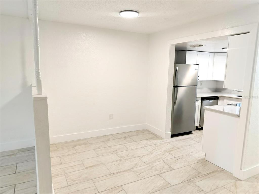 9901 Grace Drive Port Richey, FL 34668 - Photo 32 of 35 a kitchen with a refrigerator and a stove