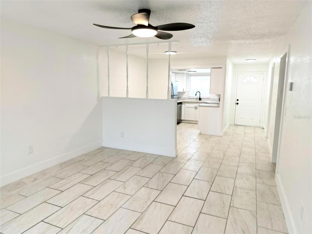 9901 Grace Drive Port Richey, FL 34668 - Photo 33 of 35 a view of a kitchen with white cabinets and chandelier