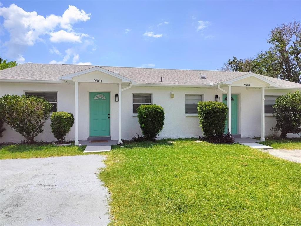 9901 Grace Drive Port Richey, FL 34668 - Photo 35 of 35 a view of a house with a yard and potted plants