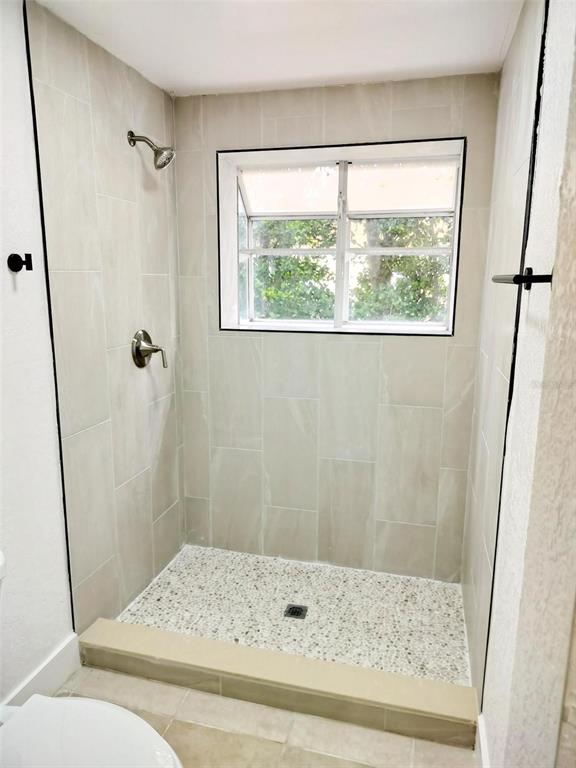 9901 Grace Drive Port Richey, FL 34668 - Photo 8 of 35 a bathroom with a window and a shower
