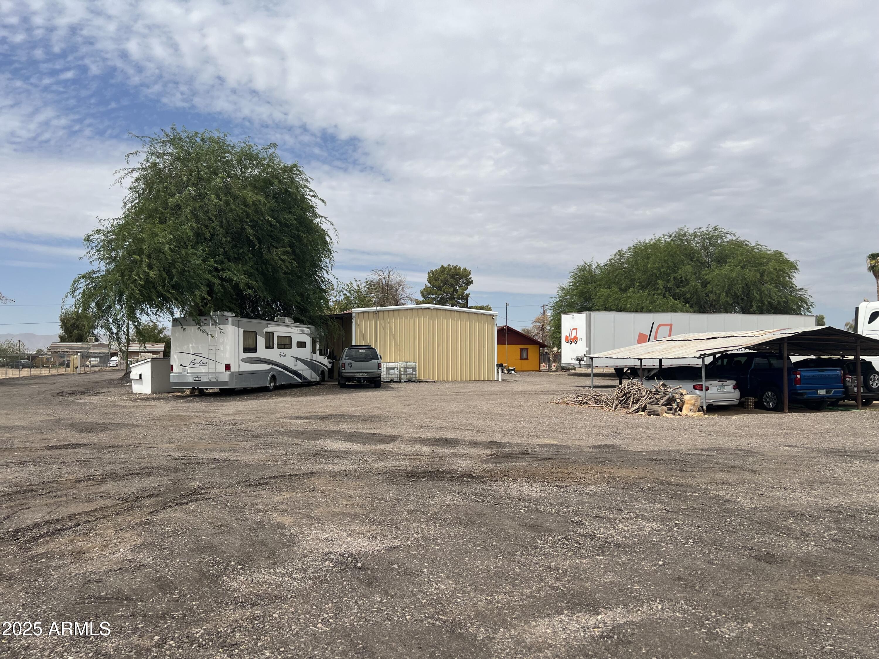 7621 North Alsup Road, Unit REAR Litchfield Park, AZ 85340 - Photo 21 of 26 a car parked in front of a white house