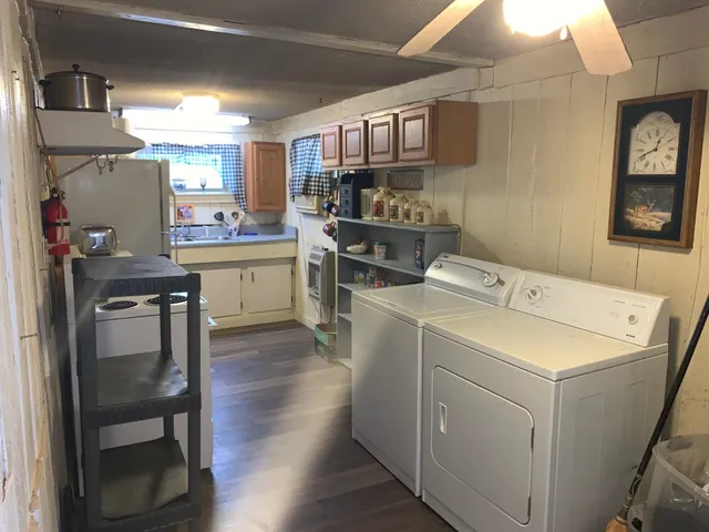 a kitchen with a sink cabinets and wooden floor