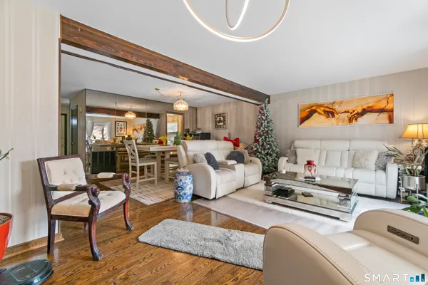 a living room with furniture and a chandelier