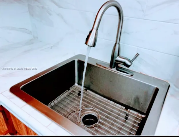 a dining room with furniture and a chandelier