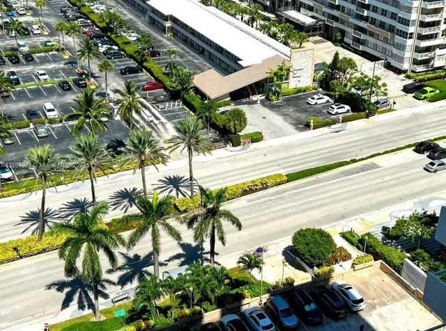 a dining room with furniture a large window and a chandelier